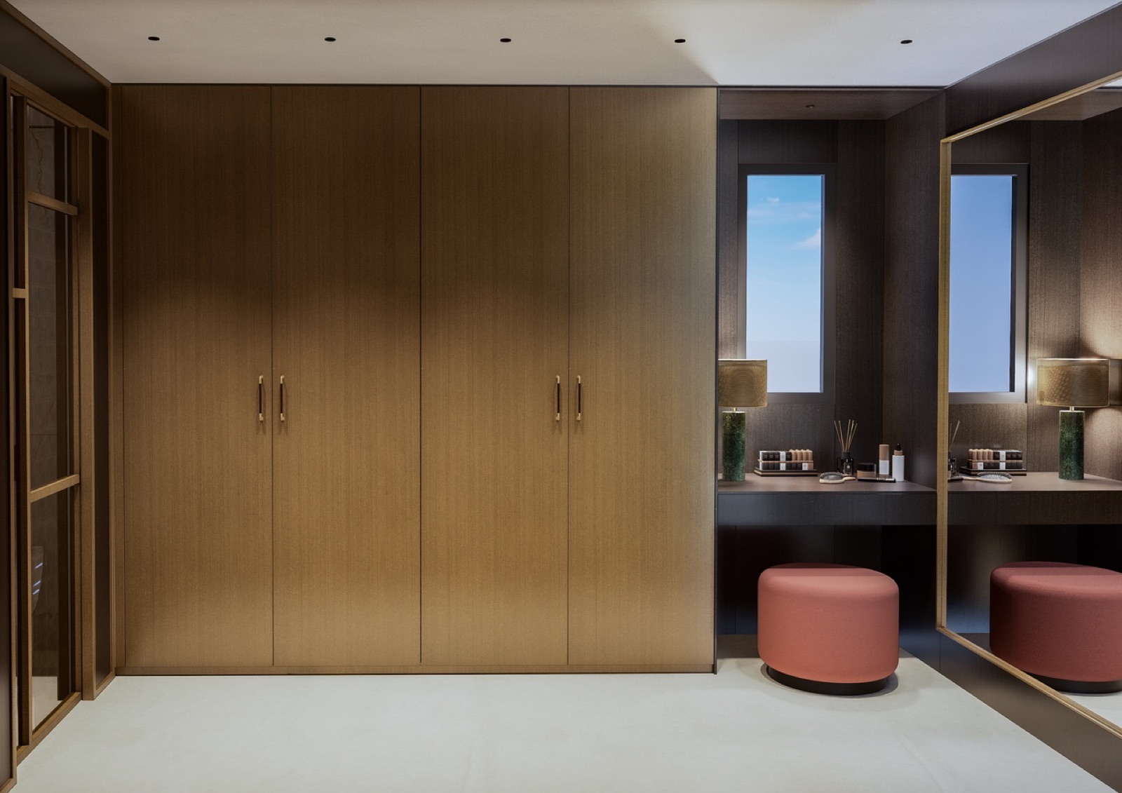 Walk-in dressing room with brass cabinetry